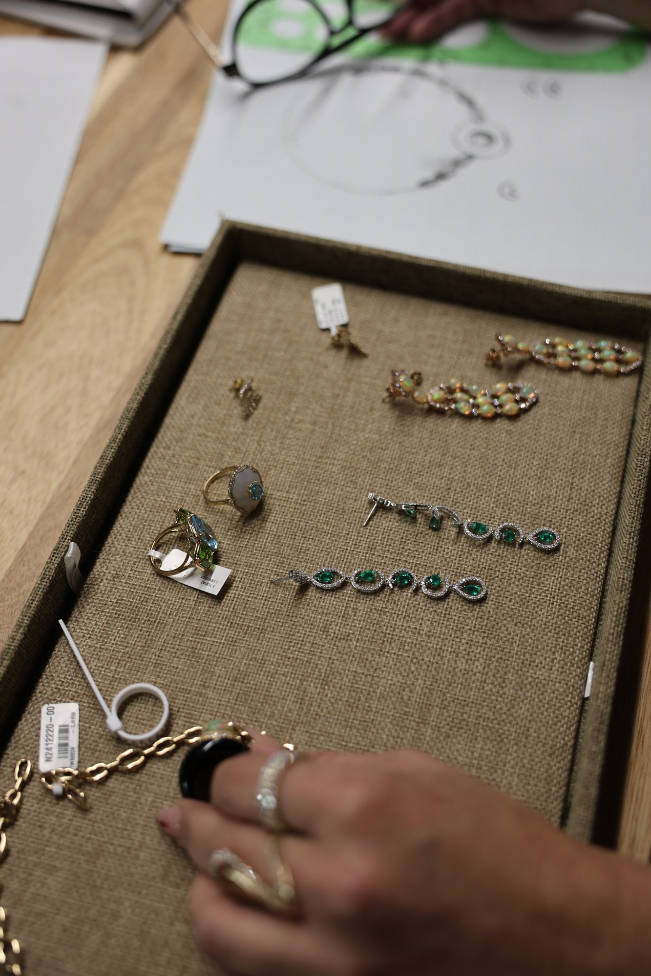 Jewelry tray of gemstone earrings and rings inside the Koru atelier