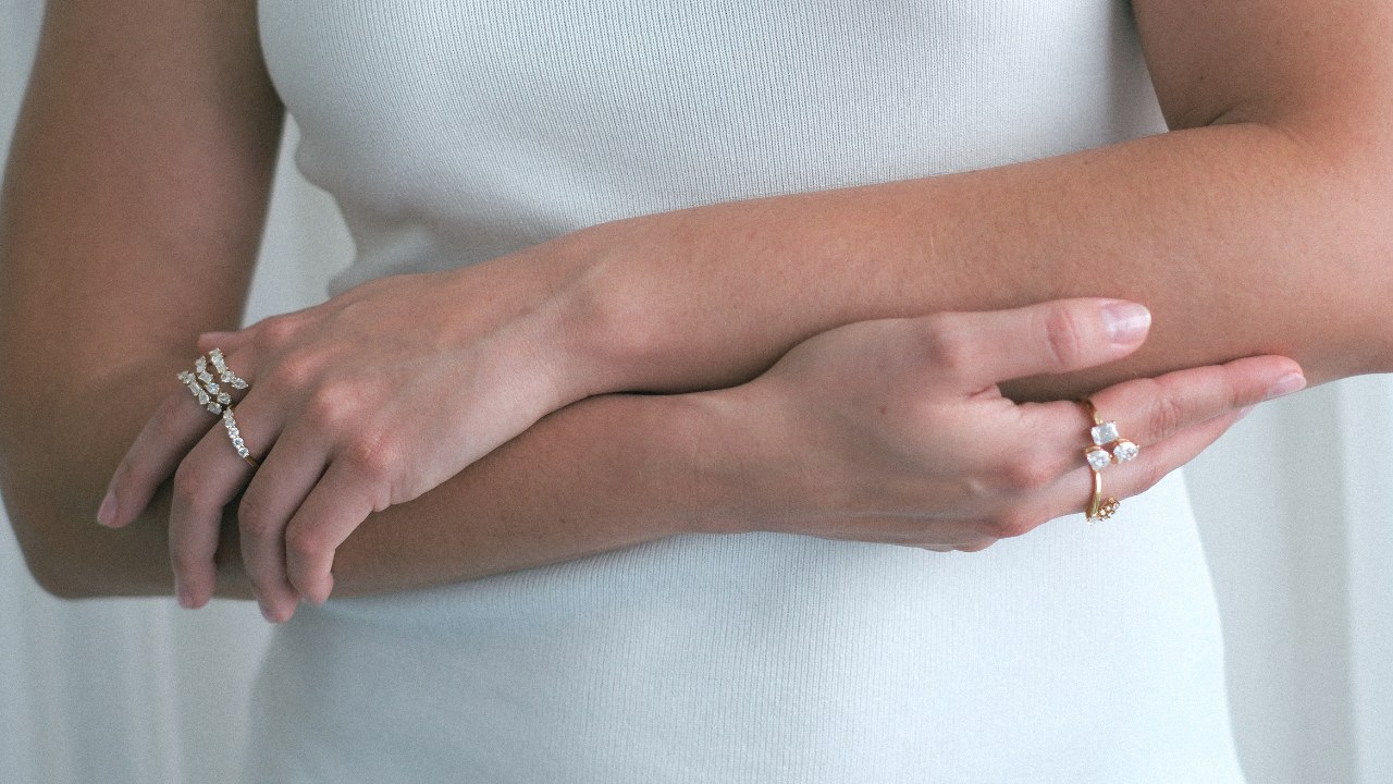 Diamond bands and a stacked ring worn on crossed hands